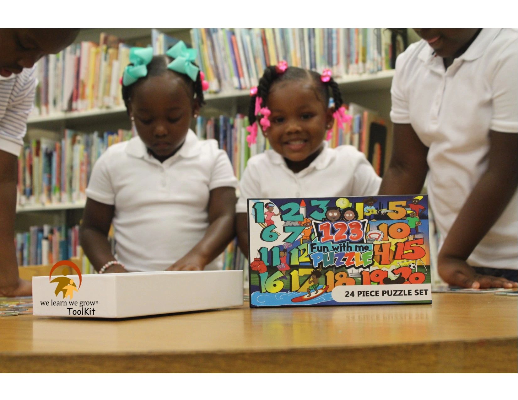Children playing with a colorful 24-piece puzzle set in a library.