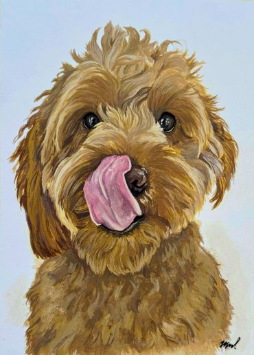 A brown dog licking its nose.