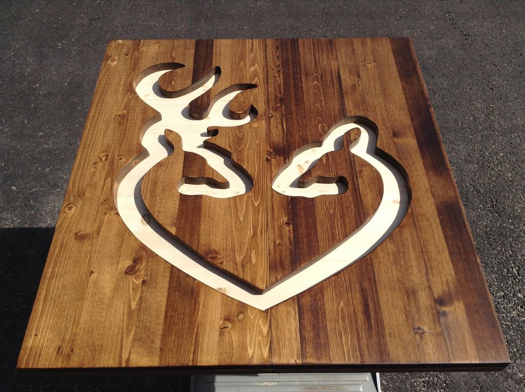 Image of two wooden deer cutouts, reminiscent of a well-known outdoors brand. One deer resembles a m
