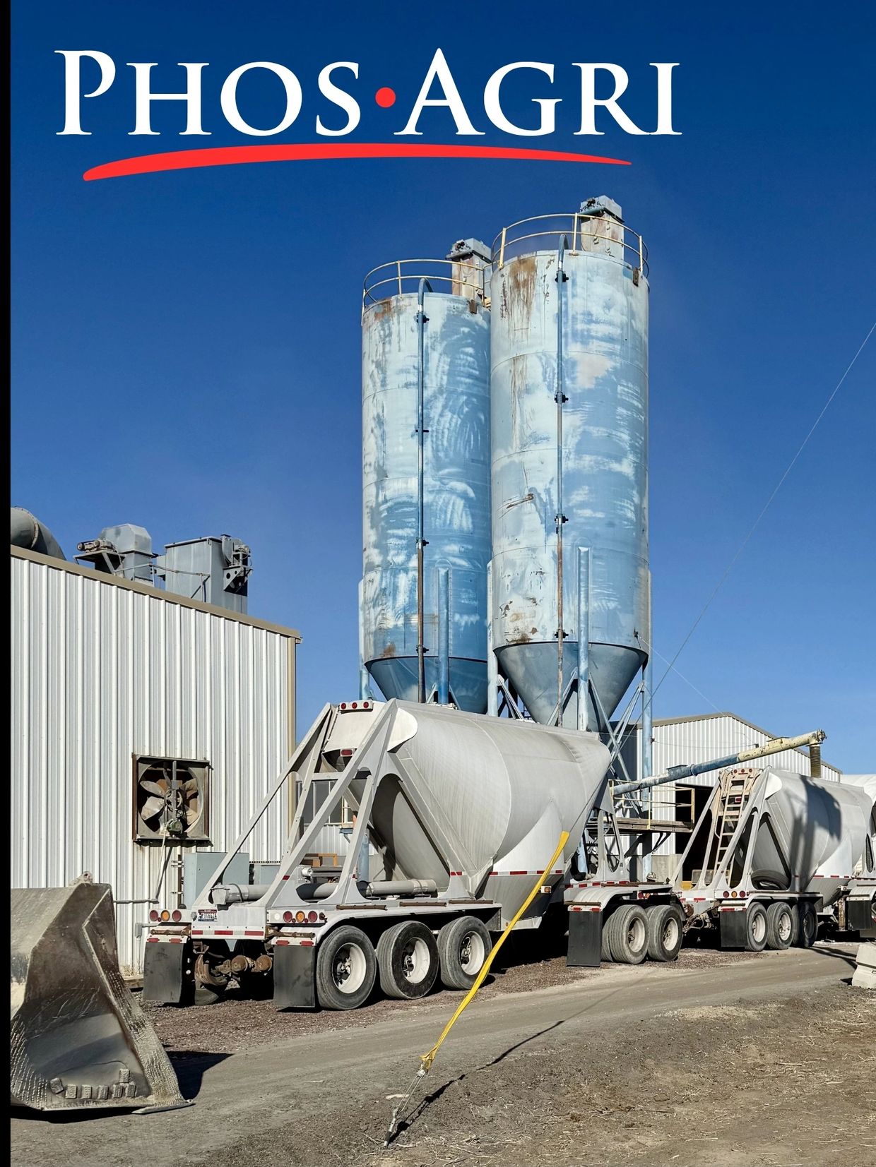 Two cement trucks parked near silos under the PhosAgri logo.