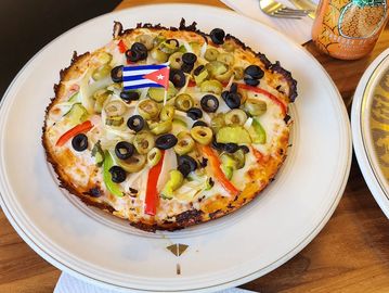 Fresh vegetables over melted cheese and savory sauce on a crispy crust. Light, colorful, and satisfy