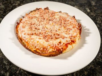 Cuban-style pizza topped with savory ham, tomato sauce and melted mozzarella cheese.
