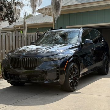 Black BMW SUV parked on a driveway.