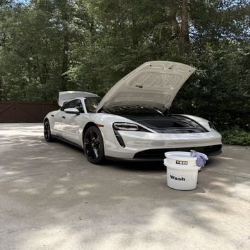 White sports car with hood open and bucket labeled 'Wash'.