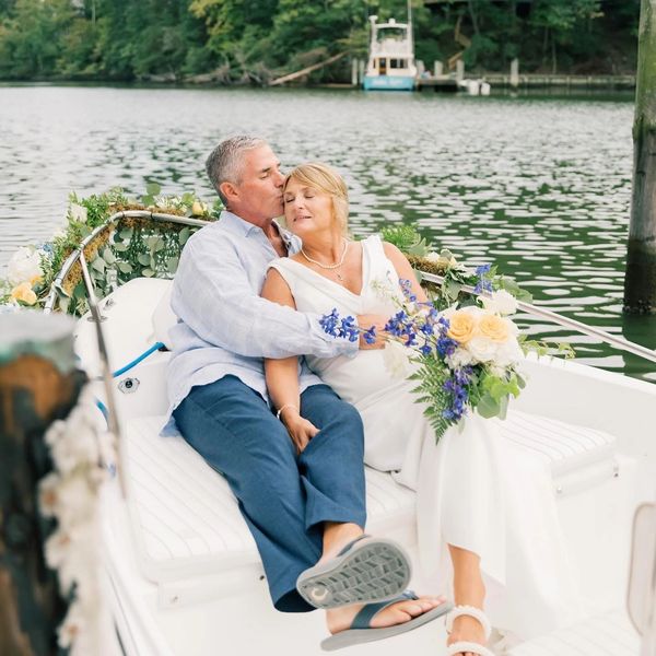 Older couple enjoying a romantic boat ride on a lake.