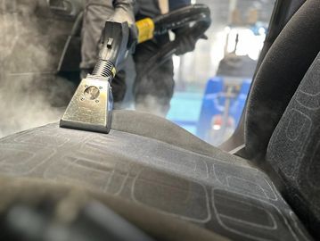 Deep steam cleaning of a vehicle seat to remove dirt, stains, and buildup.