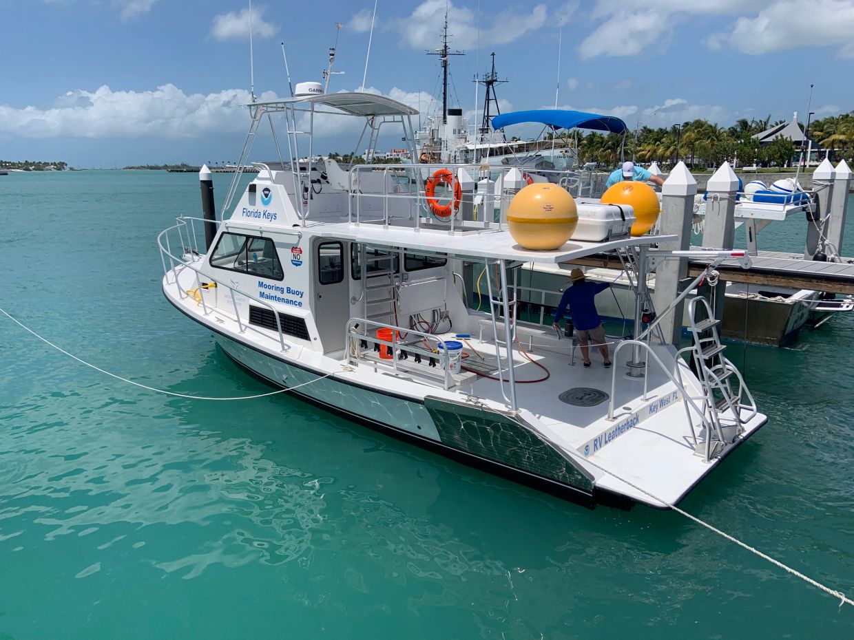 Florida Keys Mooring Buoy Maintenance boat docked in clear blue water.