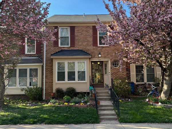 Photo of 7343 Stream Way, Springfield, VA -  a colonial townhouse flanked by 2 pink blooming cherry 