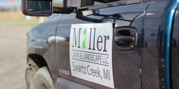 Miller Lawn and Landscape LLC logo on truck