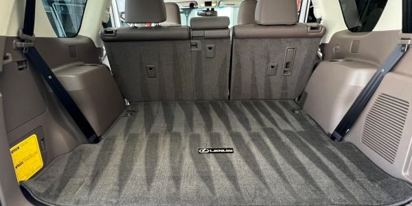 Spacious and clean Lexus SUV cargo area with folded rear seats.