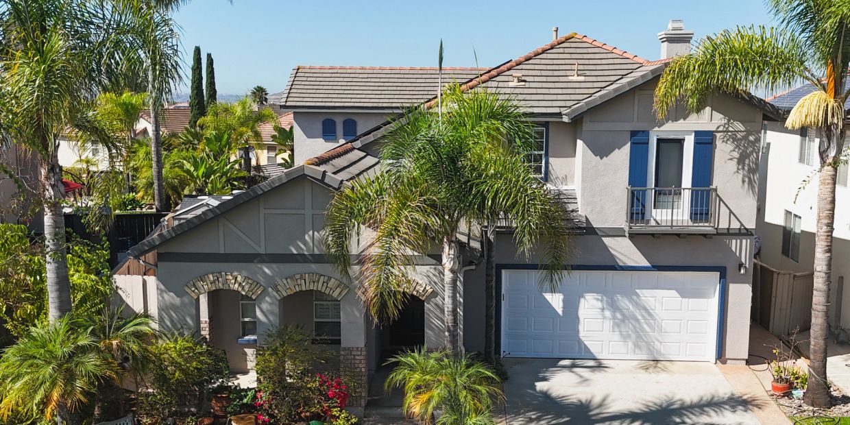 Modern two-story house with palm trees and garage