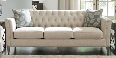 white tufted back sofa with throw pillows
