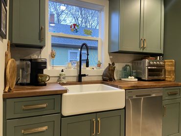 Kitchen Remodel with Green Cabinetry, farmhouse sink and Walnut Countertops