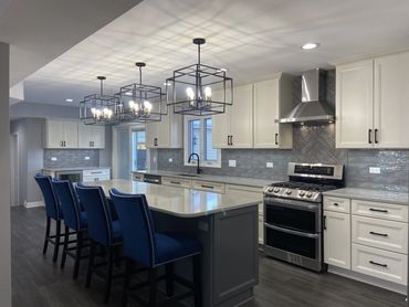 Kitchen remodel with white cabinet and island seating 