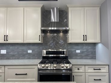 Kitchen remodel with white cabinet and stainless steal range 