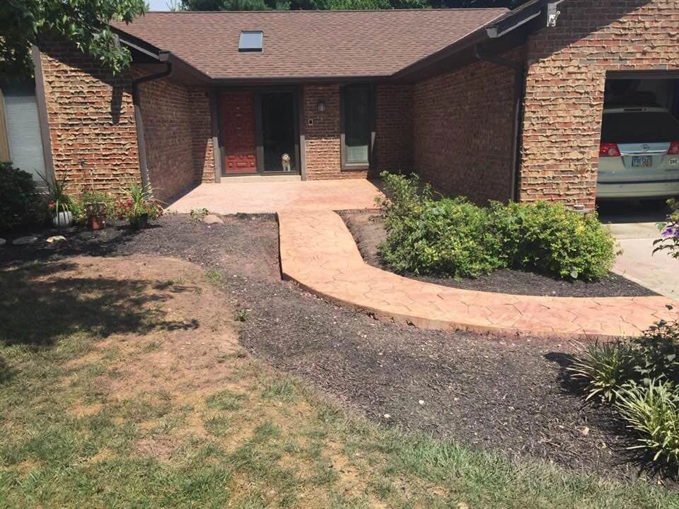 Brick house entrance with a dog sitting in doorway.
