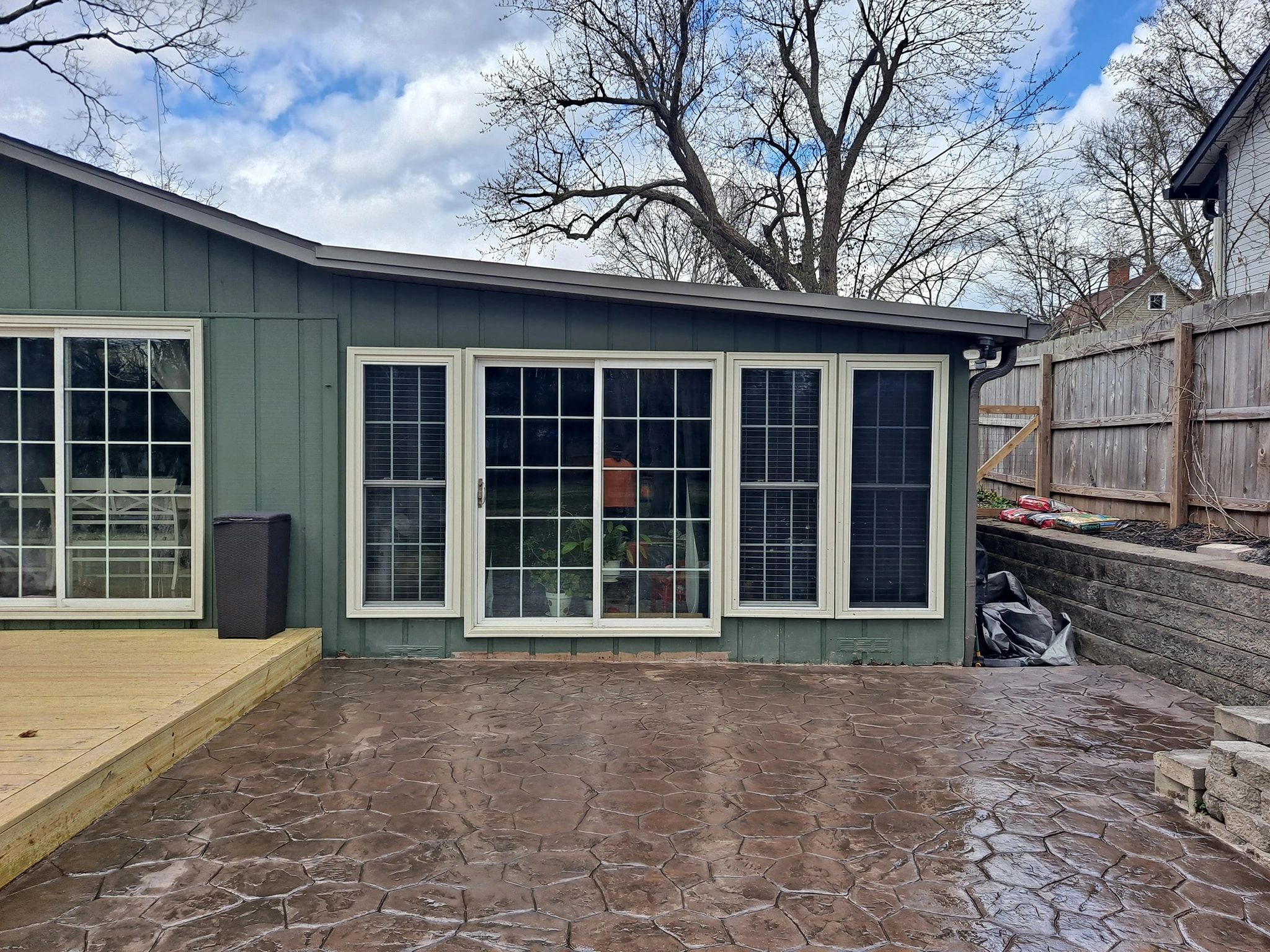 Backyard patio with sliding glass doors and fenced yard.