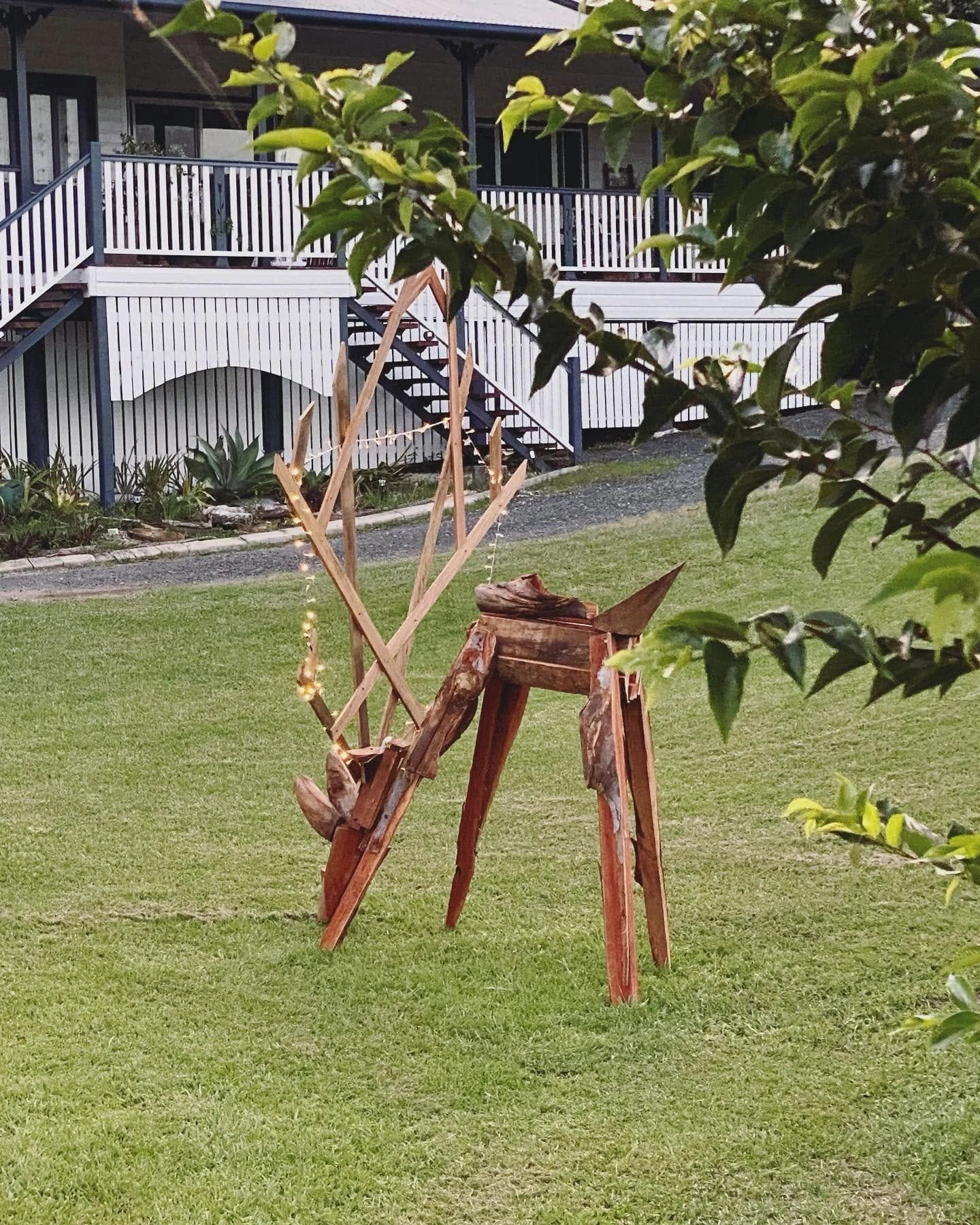 Wooden deer sculpture decorated with fairy lights.