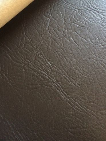 Close-up of dark brown textured leather surface.