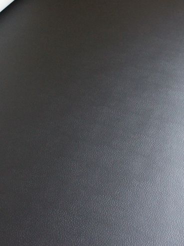 Close-up of black textured leather surface.