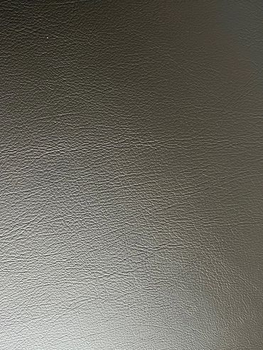 Close-up of textured dark leather surface.