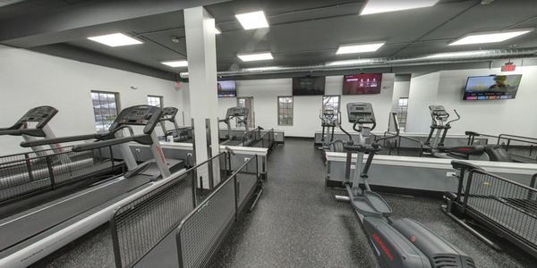 Image of the interior of a exercise health center with multiple tread mills.