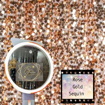 A selfie ring light mirror photo booth in front of a rose gold sequin backdrop.