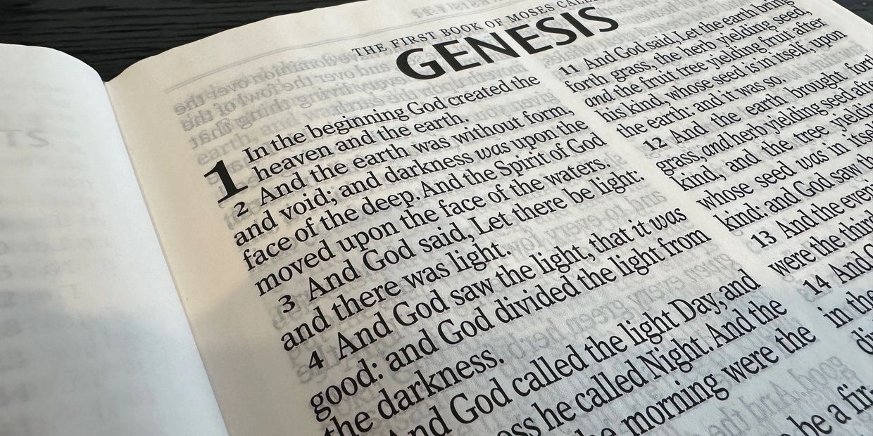 Close-up of the first page of Genesis from the Bible.