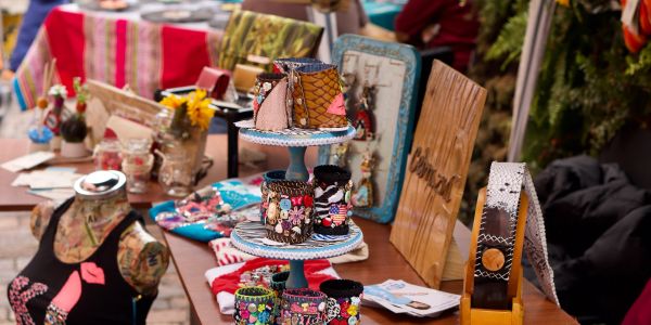Handmade fashion accessories displayed on a market table.