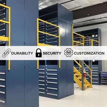 Industrial storage cabinets in a clean, organized warehouse with safety railings and stairs.