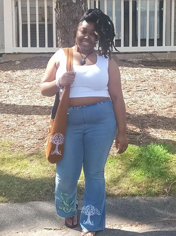 Woman with custom jeans and a custom sling bag to match