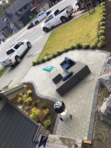Boxwood lined unique paving stone patio