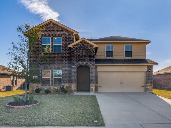 Modern two-story brick house with a two-car garage.