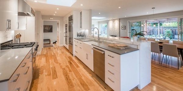 modern kitchen with hardwood floors in a orange oak finish