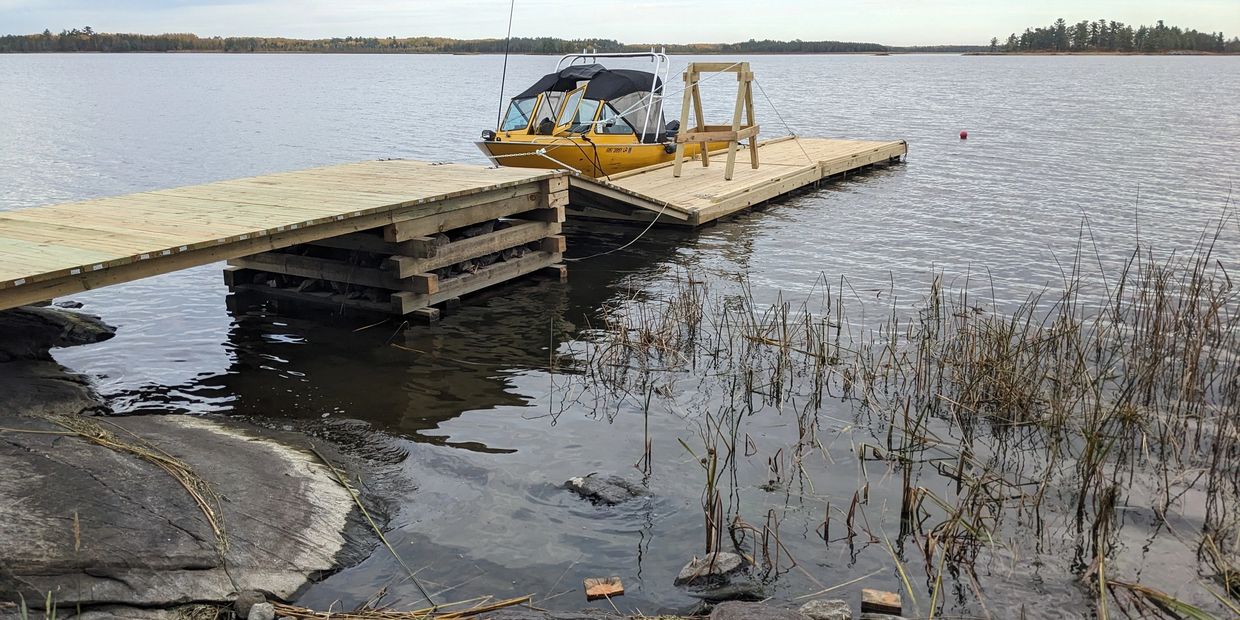 Alt text: "New dock construction at remote waterfront property on Rainy Lake by RLB Inc. — island do
