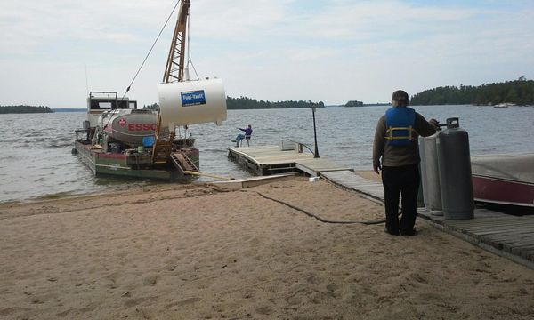  "RLB Inc. delivering Westel Fuel-Vault storage tank by crane to island cottage dock on Rainy Lake"