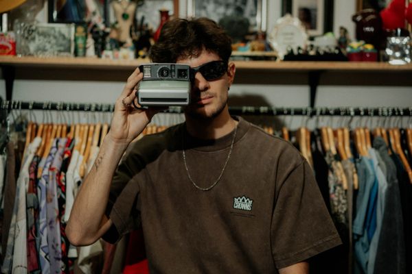 The Village Thrift Customer Taking A Polaroid Photo
