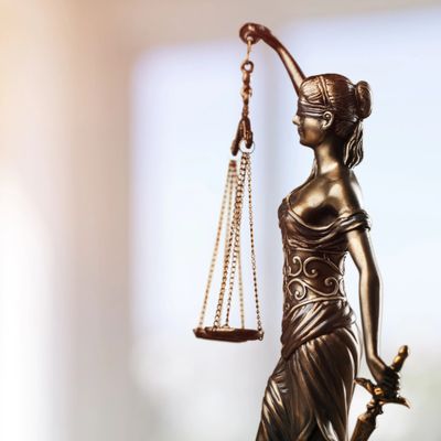 Bronze statue of Lady Justice holding scales and a sword, blindfolded.