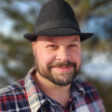 Zachary Harmon PMHNP-BC black fedora and plaid shirt.