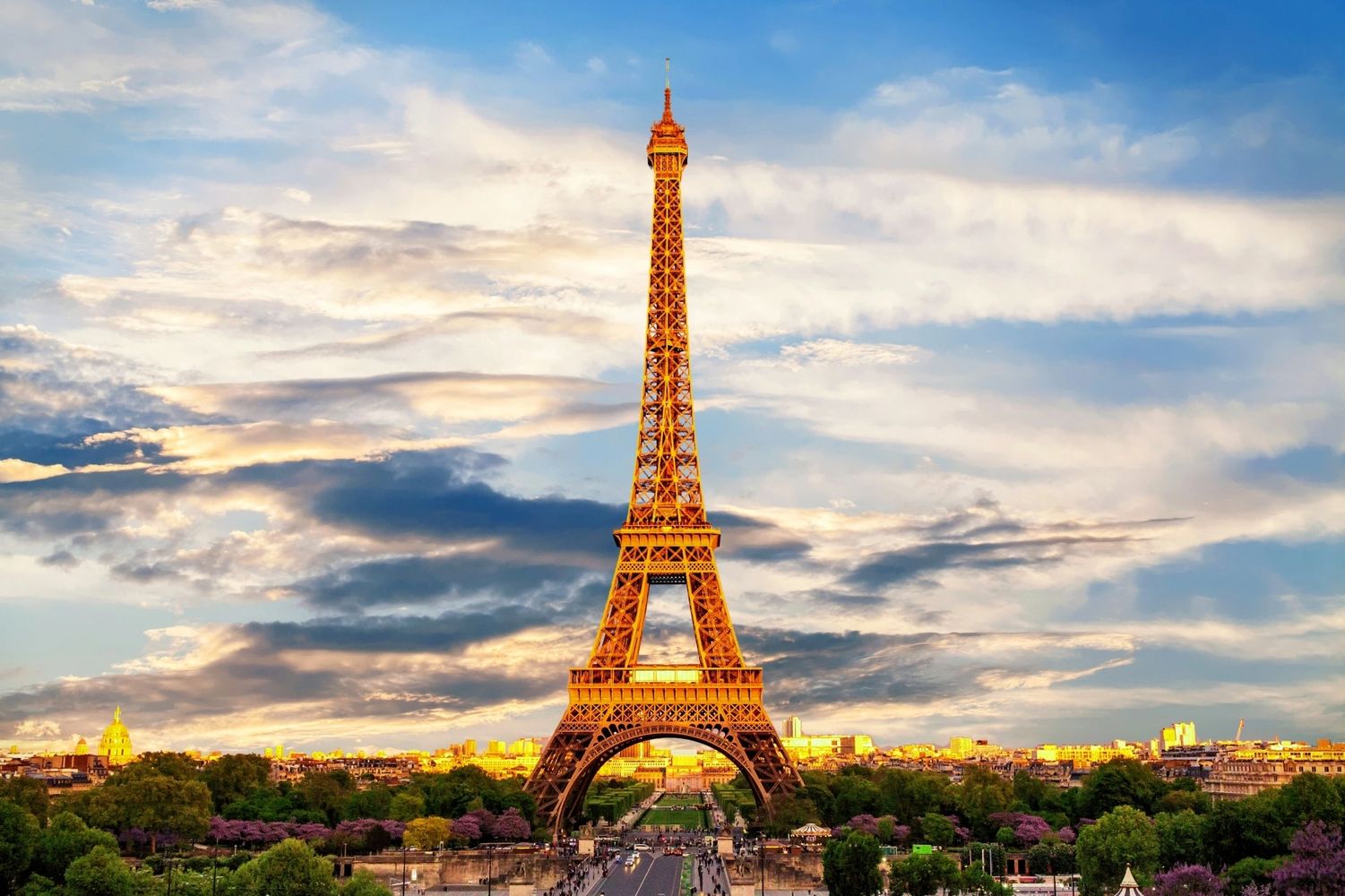 The Eiffel Tower glowing golden at sunset in Paris.