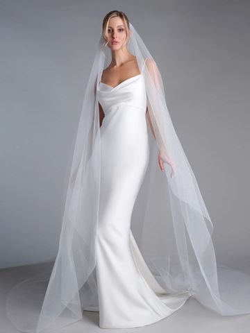 A shimmering sparkle tulle is used to create this minimalistic veil with a hint of drama. Done in an