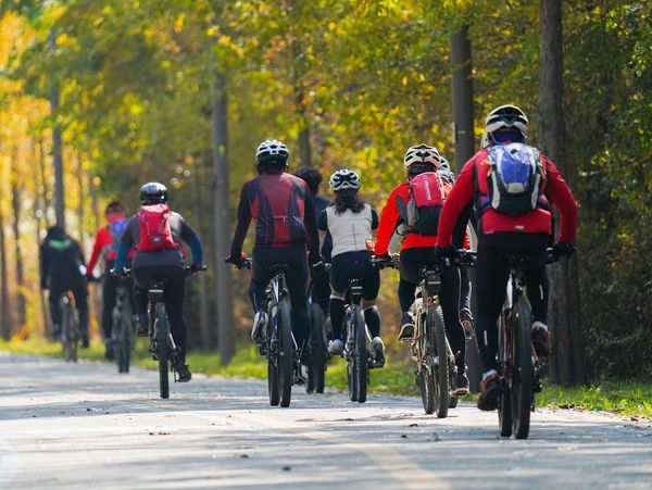 Group of cyclists on a paved trail.