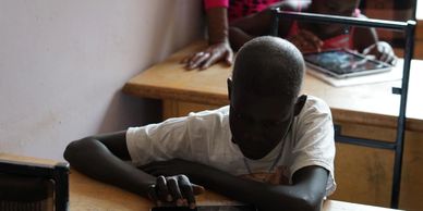 Children playing with iPads