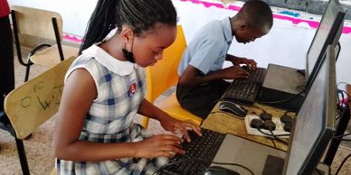 Students attending computer lab at Kitende Modern school 