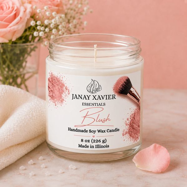 Janay Xavier Blush soy wax candle with soft pink accents and floral decor.