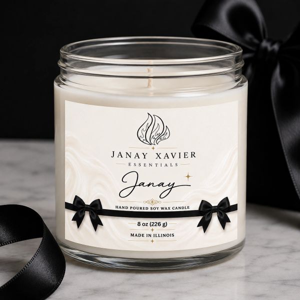 Elegant Janay Xavier soy wax candle with black ribbon bows.