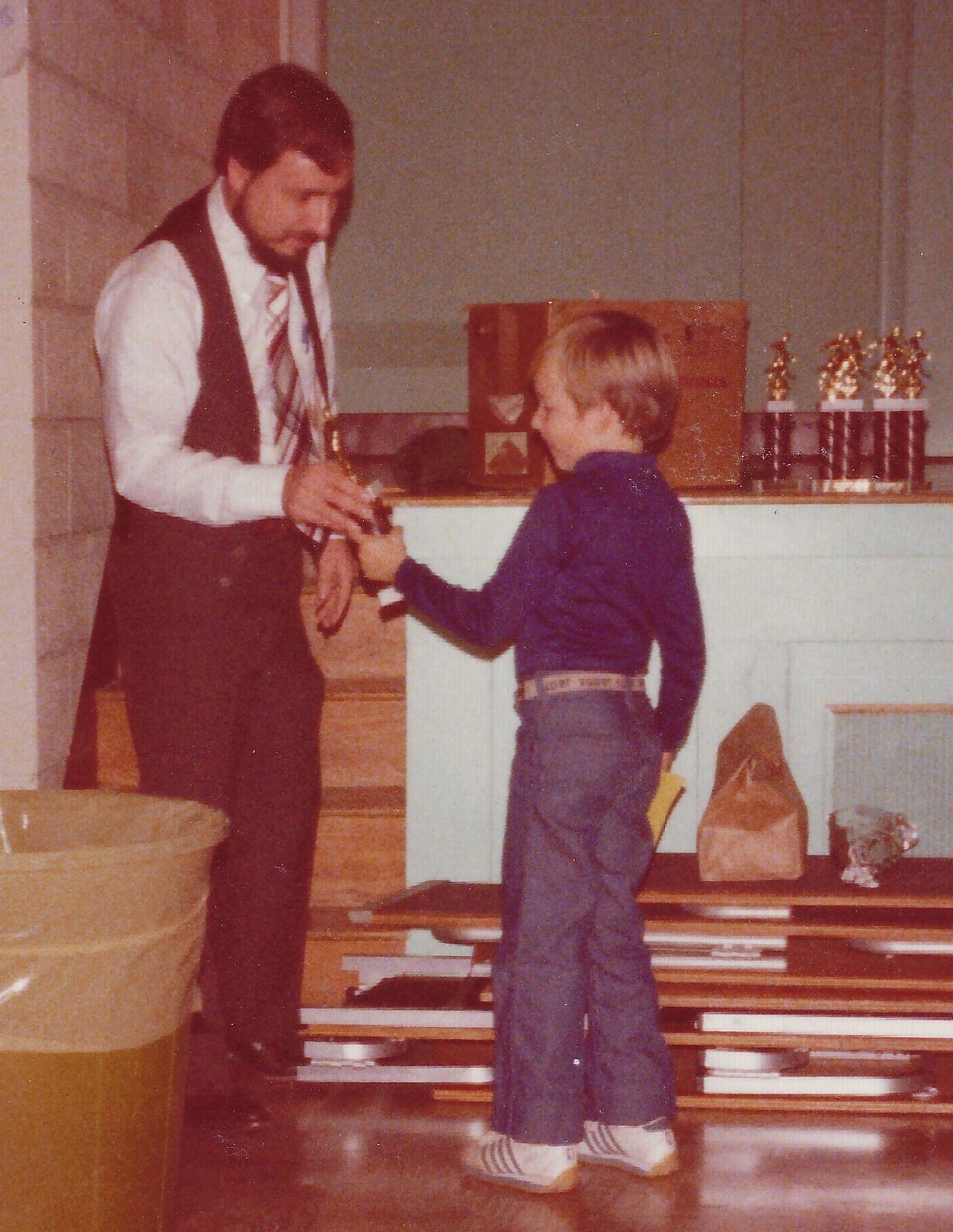 Josh receiving a soccer trophy from his father