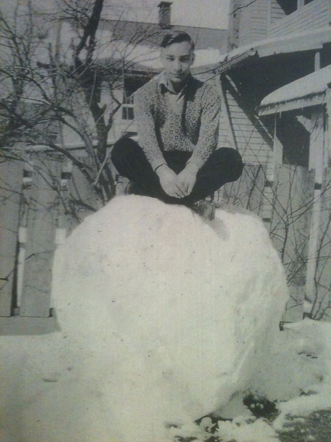 Josh's paternal grandfather sitting on a giant snowball