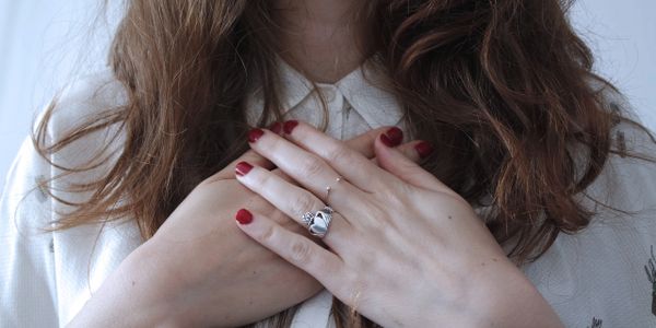 Woman with hands touching heart