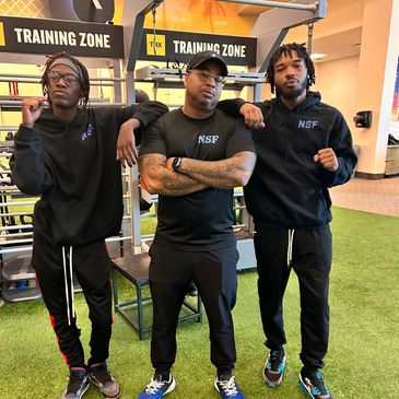 Three men wearing black clothes